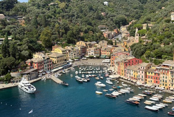 Colorful buildings and boats in Genoa harbor, Italy